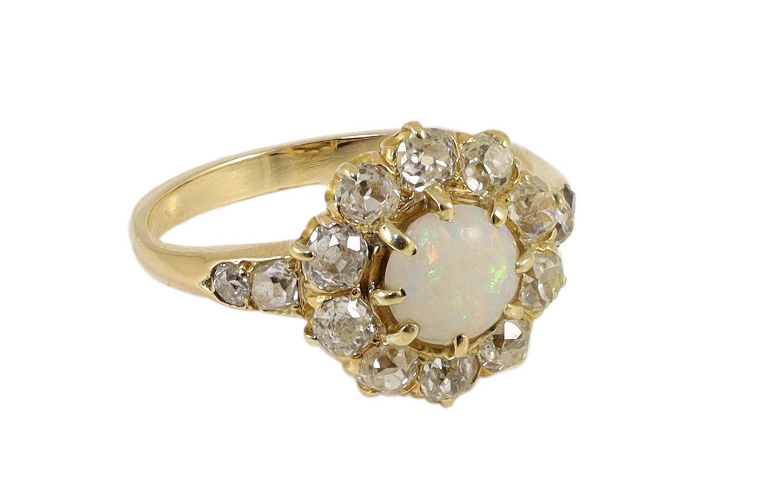 An early 20th century gold, white opal and diamond set circular cluster ring